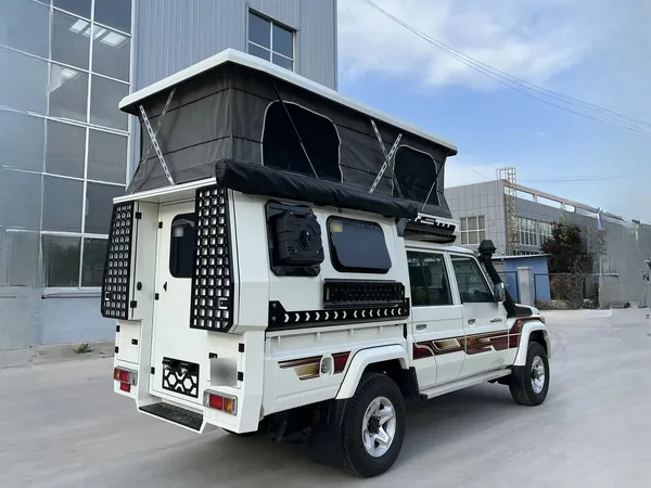 White Toyota Land Cruiser 79 with a SUNHOMEE flatbed camper, rear three-quarter view