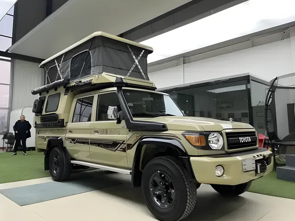 Khaki Toyota Land Cruiser 79 with a flatbed camper and pop-up roof