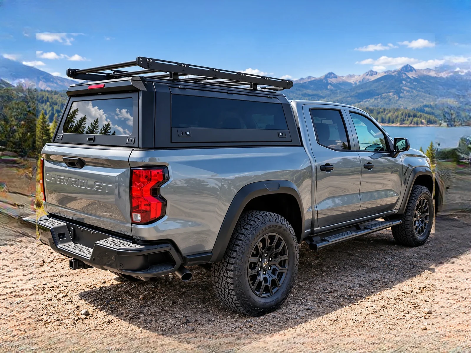 Aluminum truck topper with roof rack on a grey midsize pickup