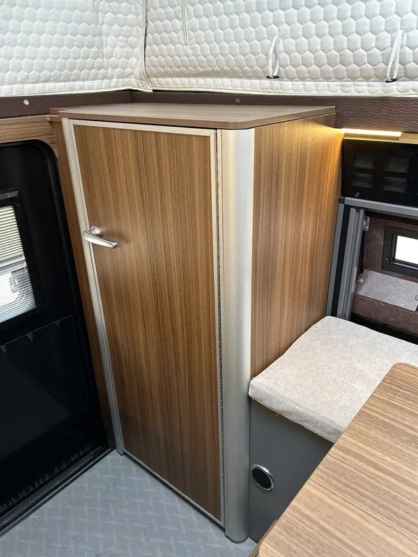 Wood-finish wardrobe cabinet inside the camper