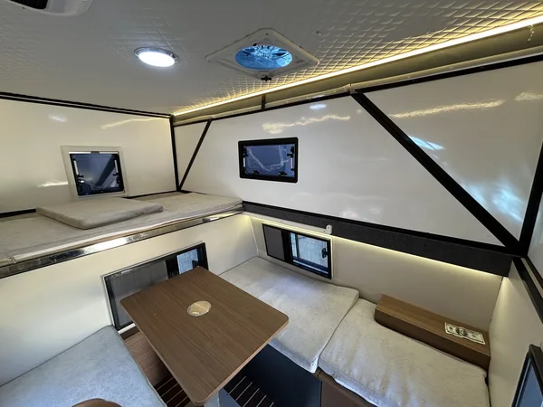Hard-top pop-up camper interior with dinette table