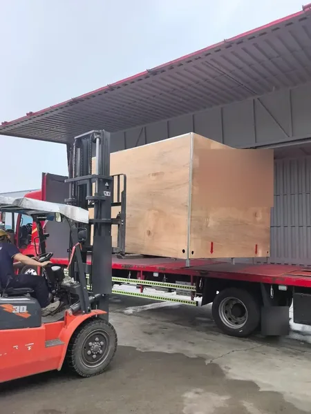 Export crate being loaded onto a truck by forklift